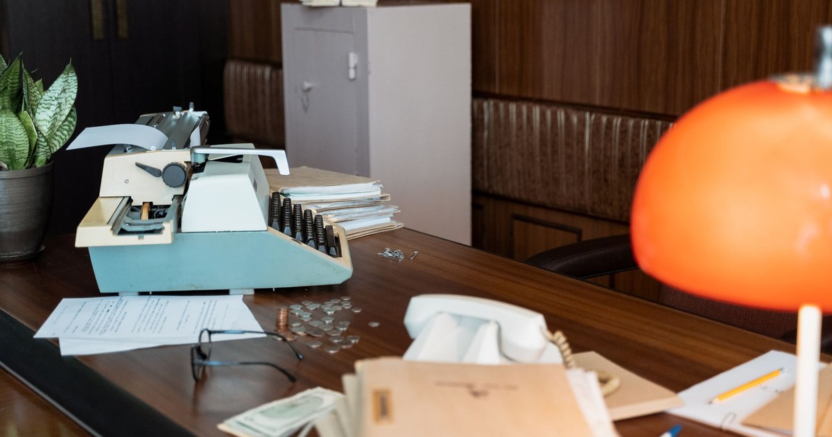 A nostalgic office scene with a vintage typewriter on a wooden desk.