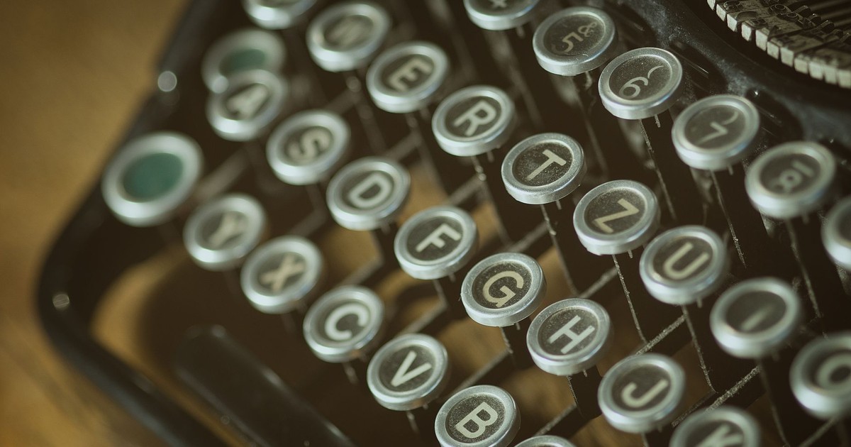Close-up view of a vintage typewriter keyboard with round keys from an old typing device.