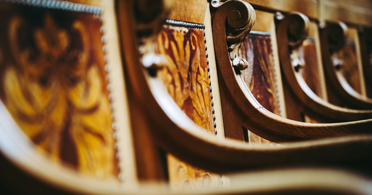 Close-up of ornate wooden chairs inside the Swiss Parliament building in Bern, Switzerland.