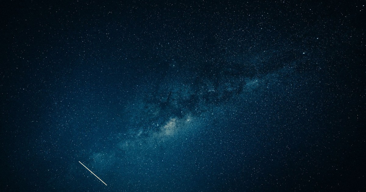 Captivating view of the Milky Way galaxy and a shooting star across a clear night sky.