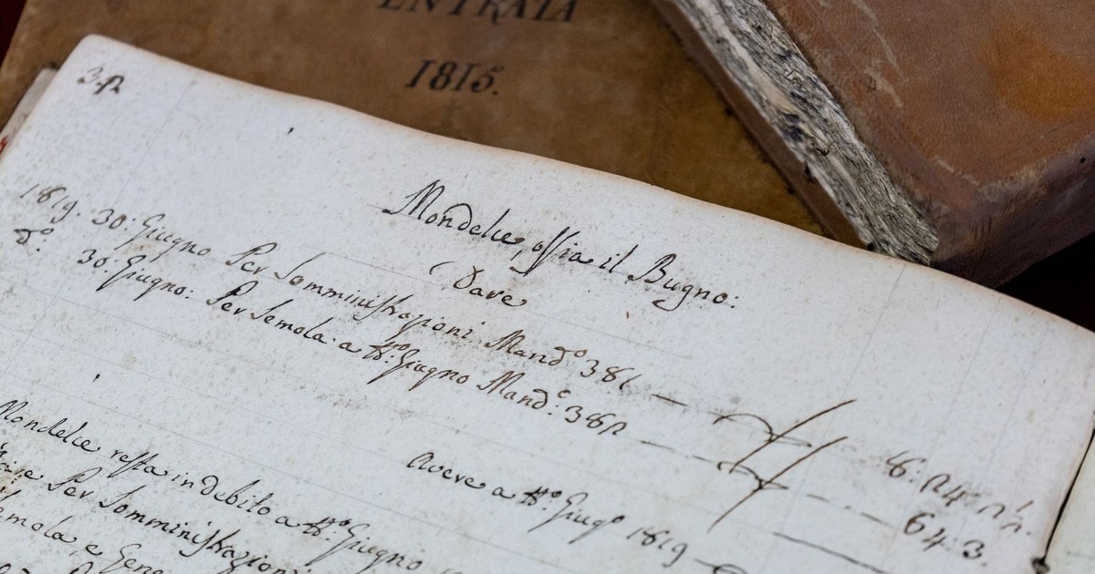 Detailed close-up of 19th-century handwritten documents and antique books.