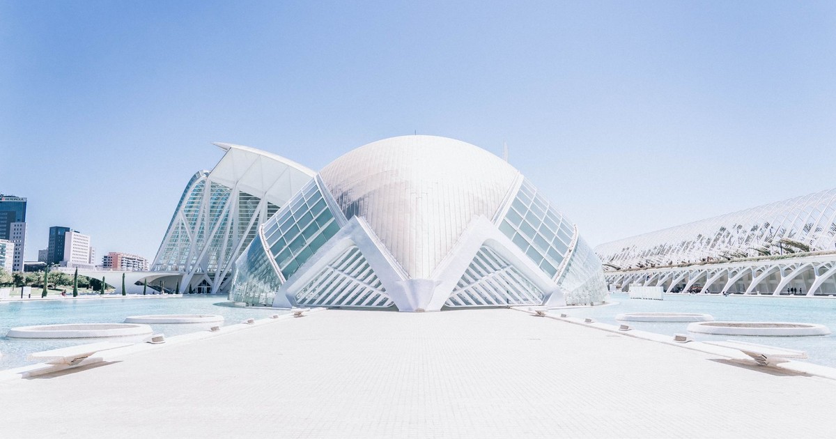 Futuristic architecture of the City of Arts and Sciences in Valencia, Spain, featuring the striking dome structure and clear skies.