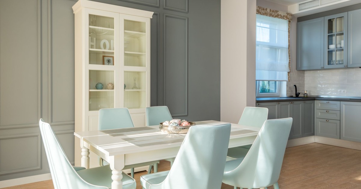 Elegant dining area featuring light blue chairs and a chic cabinet for a tranquil home interior.