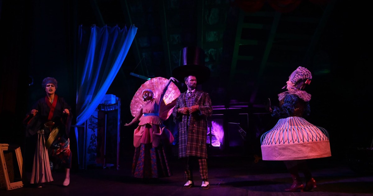 Vibrant costumes and dramatic lighting in a theatrical stage performance.