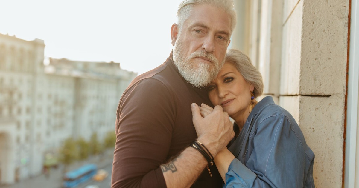 A senior couple embracing tenderly outdoors, showcasing love and connection.