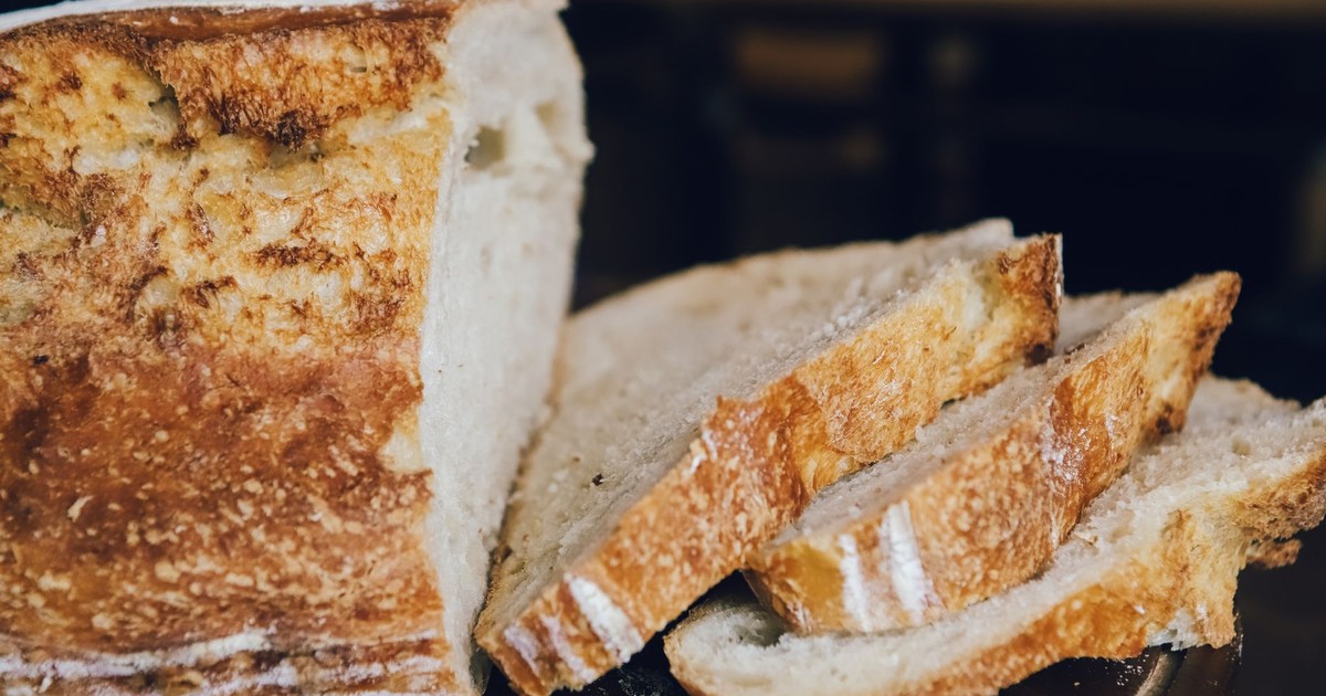 A detailed view of sliced artisan bread with a rustic crust and soft interior.