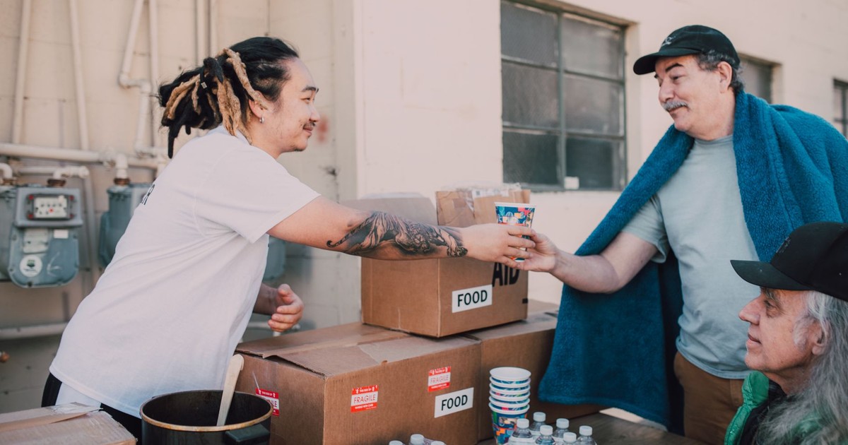 Volunteers distribute food and aid packages to those in need, fostering community support.