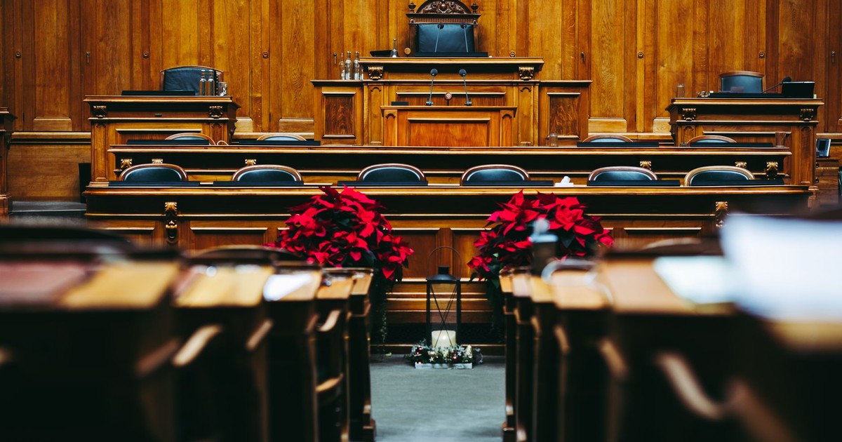 Spacious and elegant wooden courtroom with empty seats, located in Bern, Switzerland.