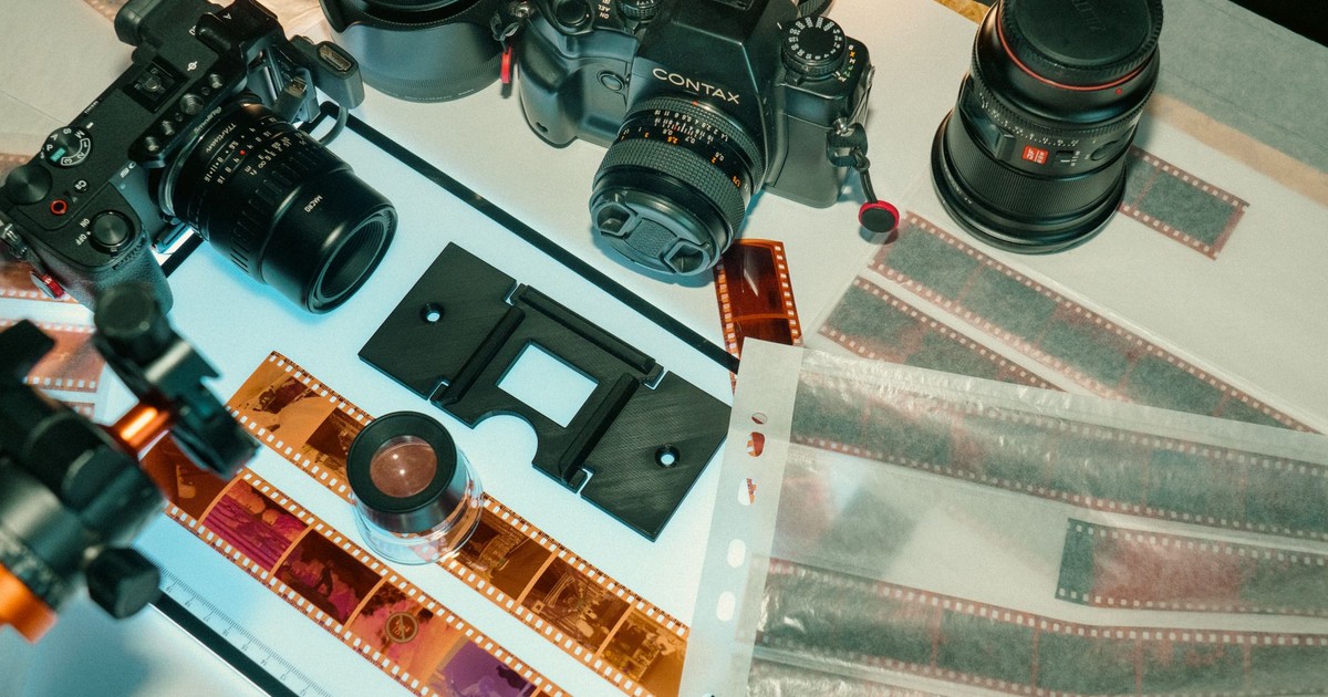 A detailed arrangement of analog photography equipment including cameras and film strips.