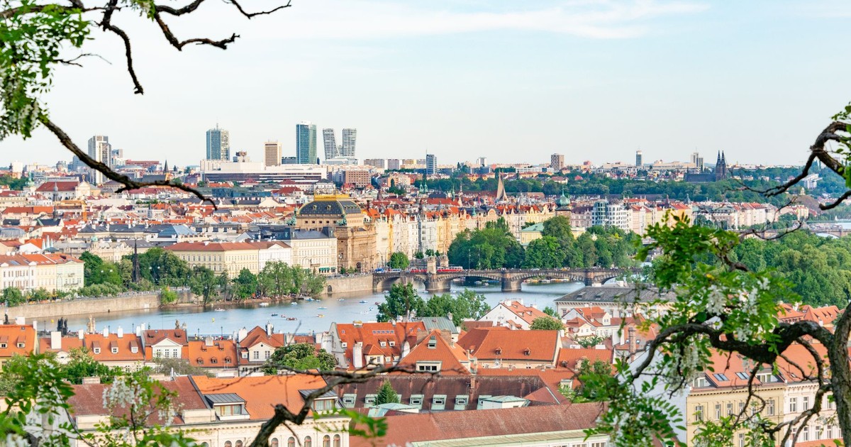 A beautiful aerial shot of Prague showcasing historic architecture and lush greenery along the Vltava River.