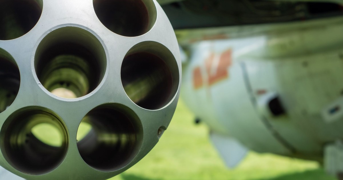 Detailed close-up of an aircraft's gun barrel with blurred background.