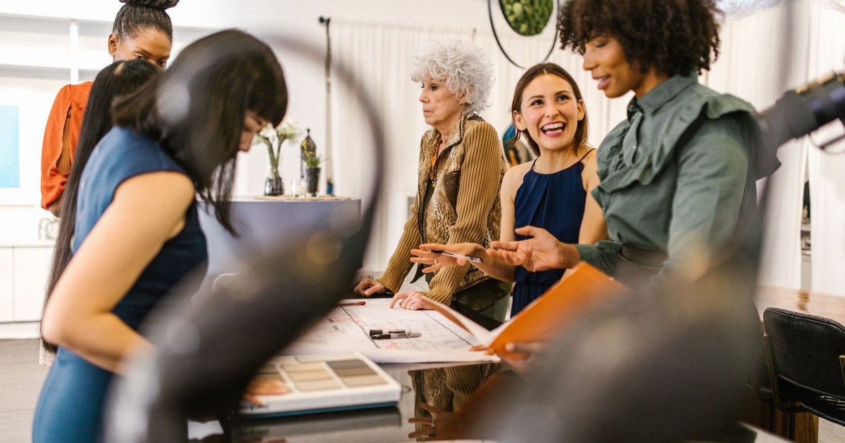 A group of diverse businesswomen having an interactive meeting in a modern office setting.