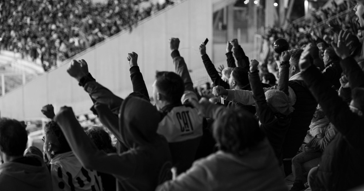 Vibrant crowd of football fans cheering in a Córdoba stadium, Argentina.