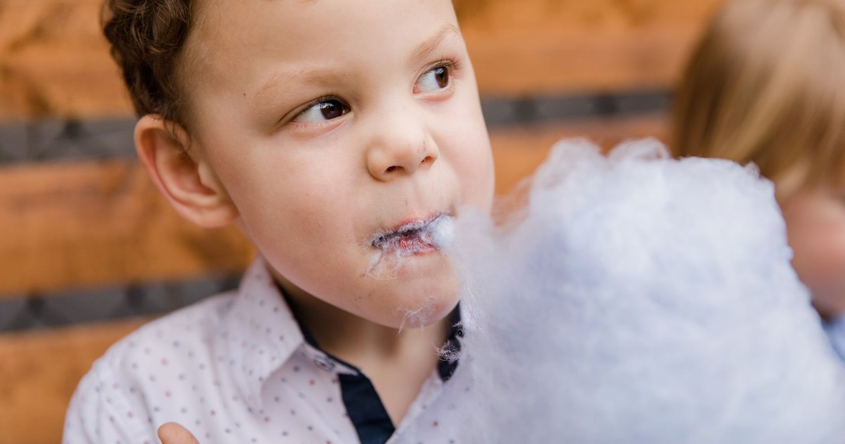 A child delighting in cotton candy, capturing a playful and sweet moment.