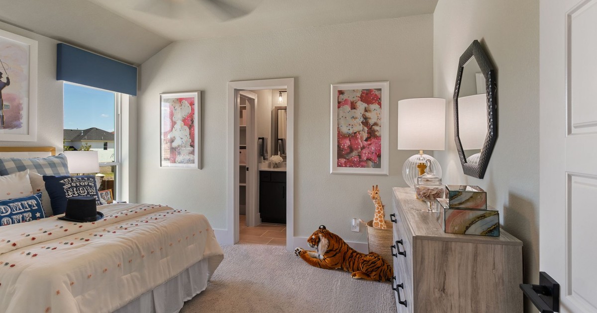 Bright modern bedroom with stylish decor, plush toys, and soft lighting, perfect for contemporary homes.