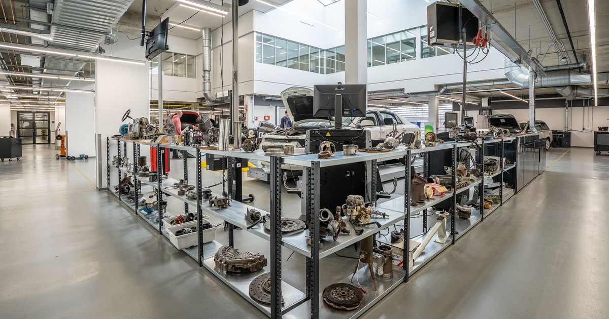 Spacious auto workshop showcasing various car parts and repair equipment.