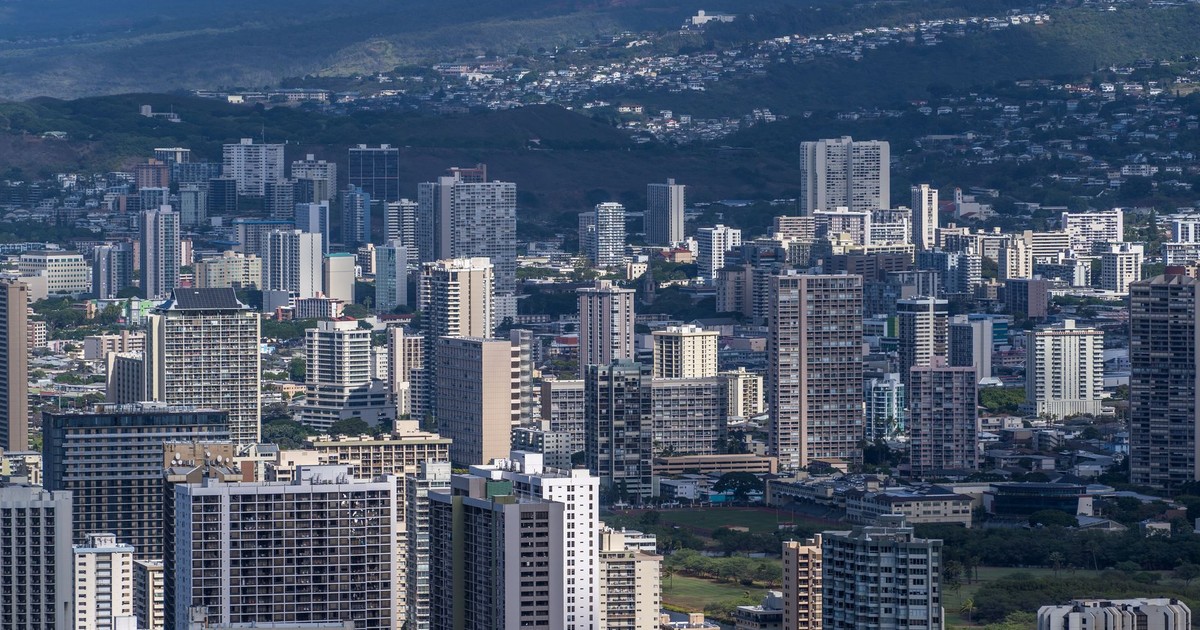 Stunning aerial view of Honolulu's urban skyline featuring modern skyscrapers under a clear sky.