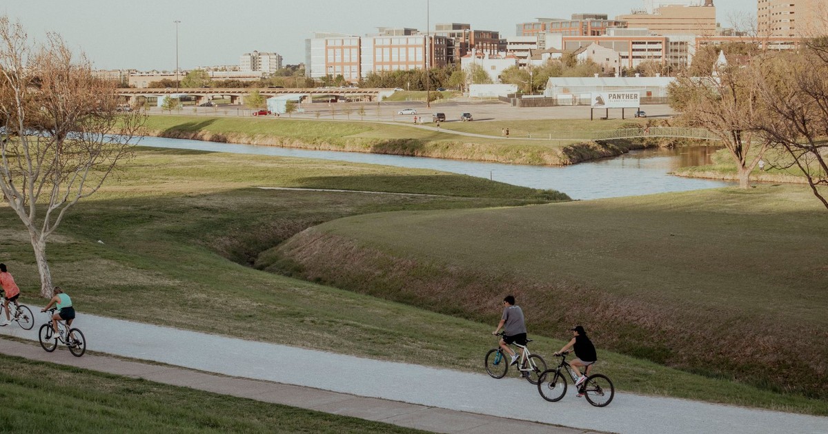 Bicyclists ride along a scenic path in Fort Worth, capturing the essence of outdoor activity.