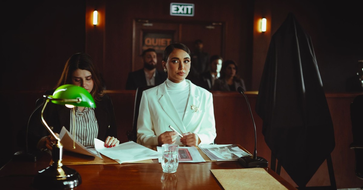 A courtroom scene in Baghdad with lawyers and participants engaged in legal proceedings.