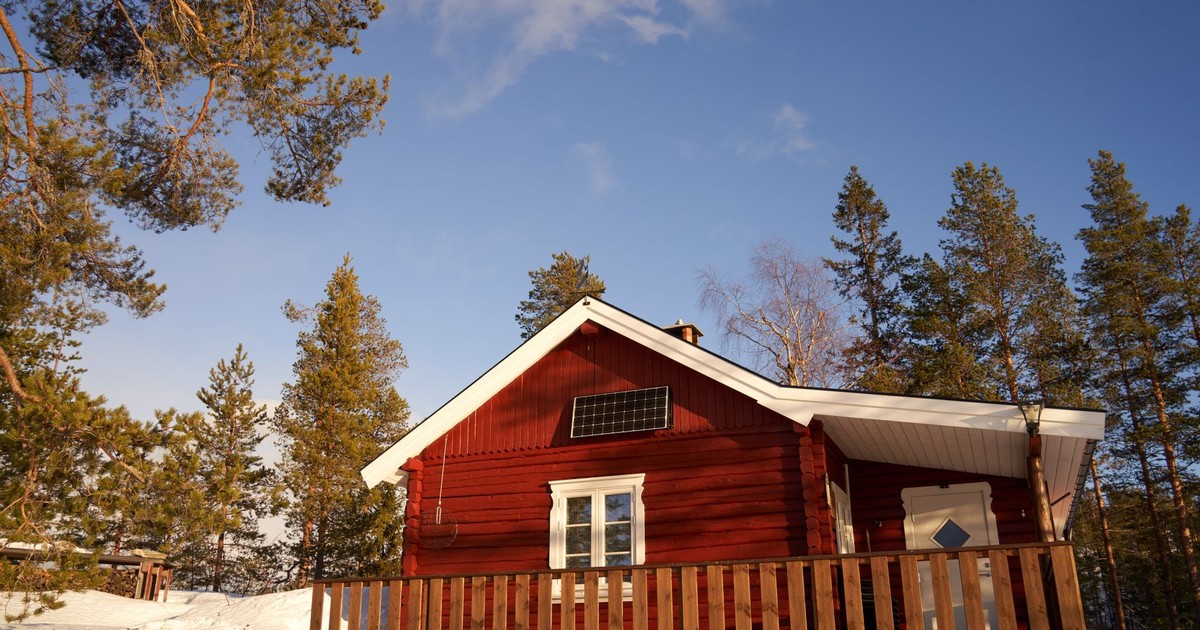 Idyllic red cabin in a serene snowy forest in Krøderen, Norway, showcasing Scandinavian simplicity.