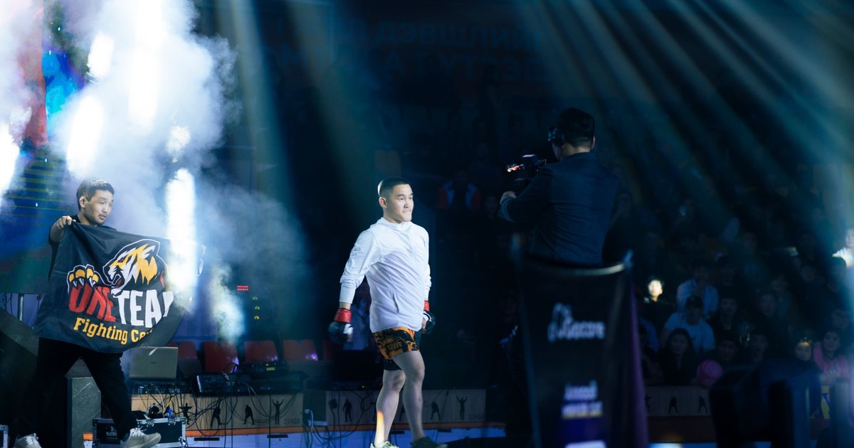 Fighter enters the arena under vibrant lights, creating an electrifying atmosphere for the audience.