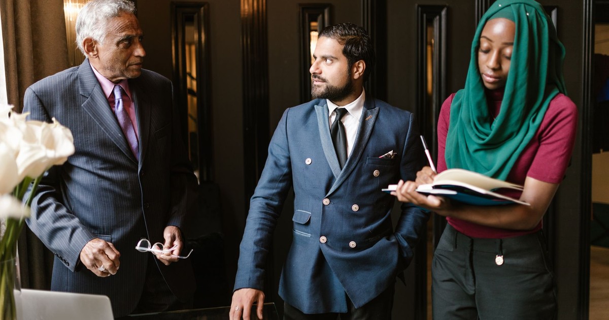A culturally diverse team engaged in a serious business discussion in an office setting.