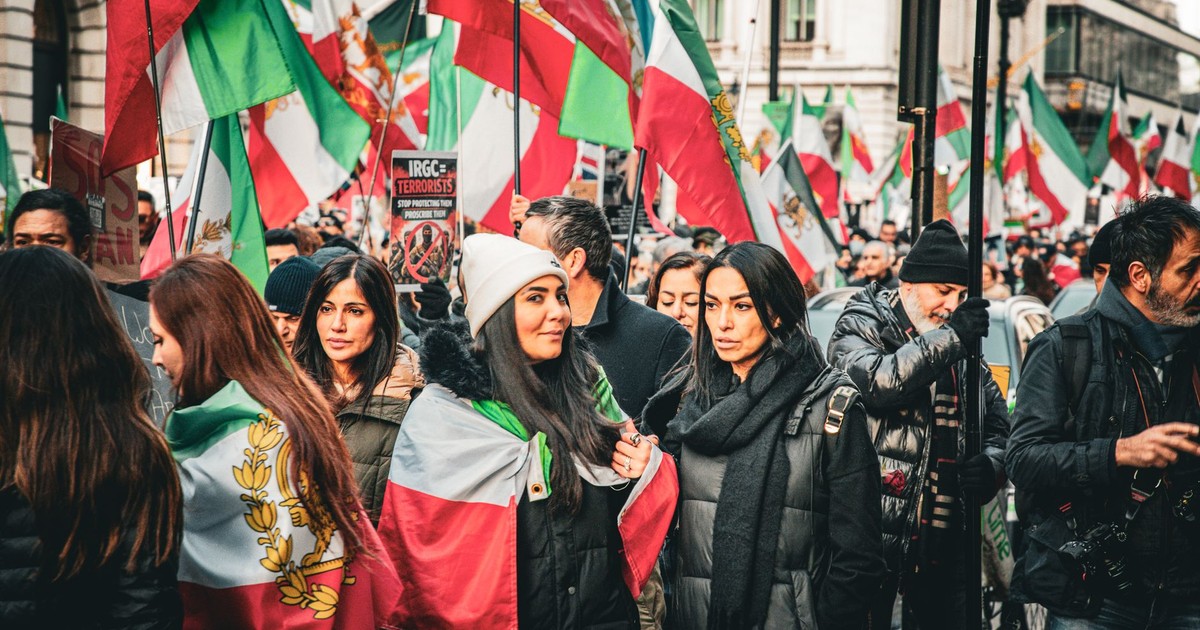 A vibrant street protest in London advocating for Iranian political change.
