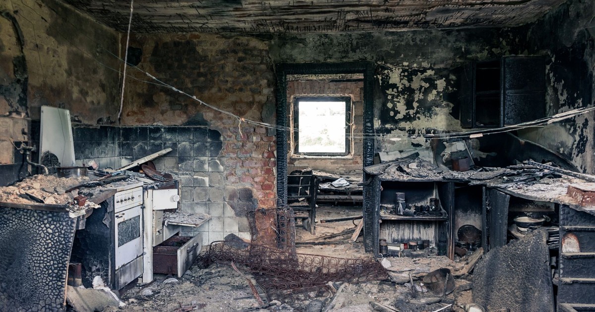 Explore an abandoned, fire-damaged kitchen illustrating decay and destruction.
