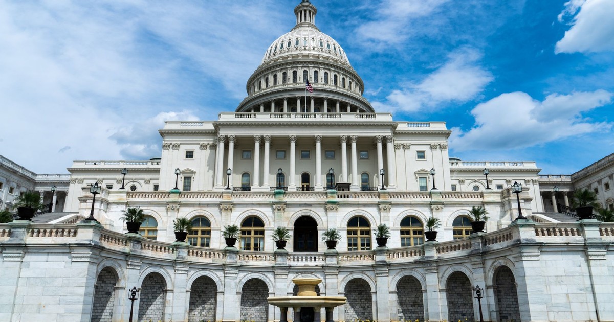 Exterior view of the iconic US Capitol Building on a sunny day in Washington, DC.