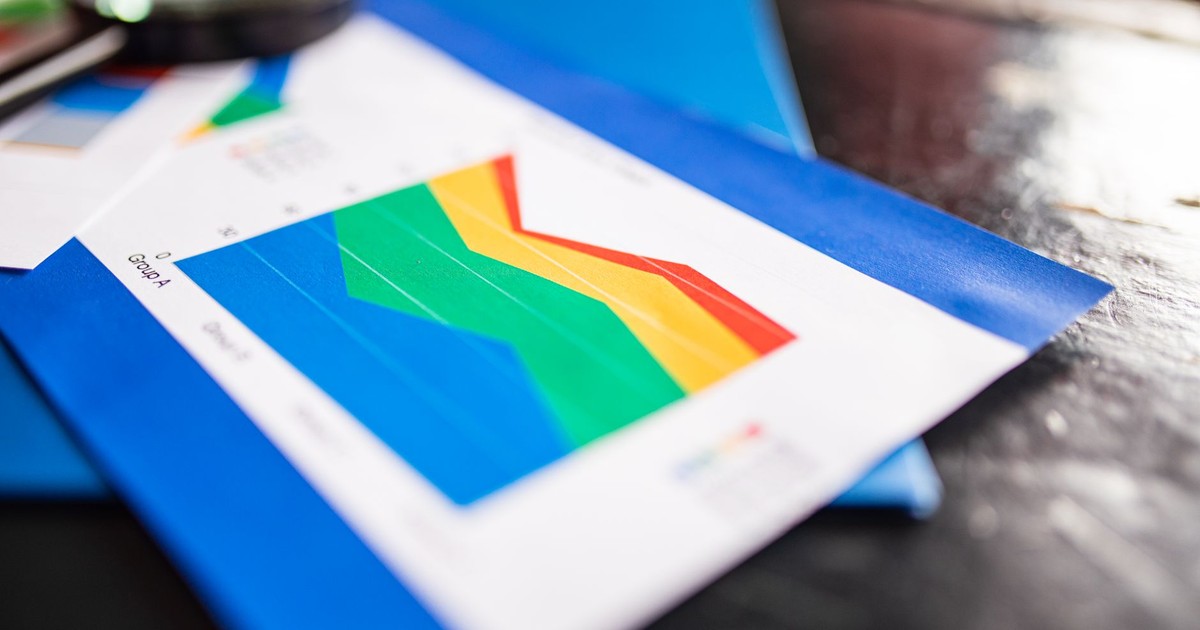 Close-up of a colorful business chart placed on a table with documents highlighting trends.