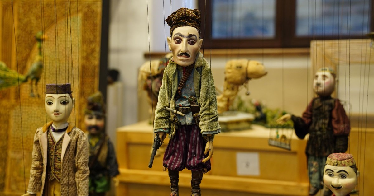 Colorful marionette puppets artfully displayed indoors, showcasing traditional craftsmanship and cultural heritage.