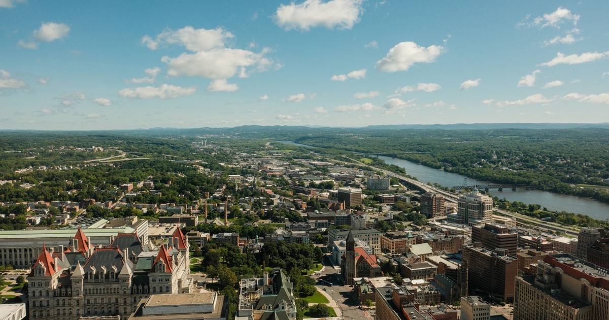 Stunning aerial shot of Albany cityscape and Hudson River on a clear day.