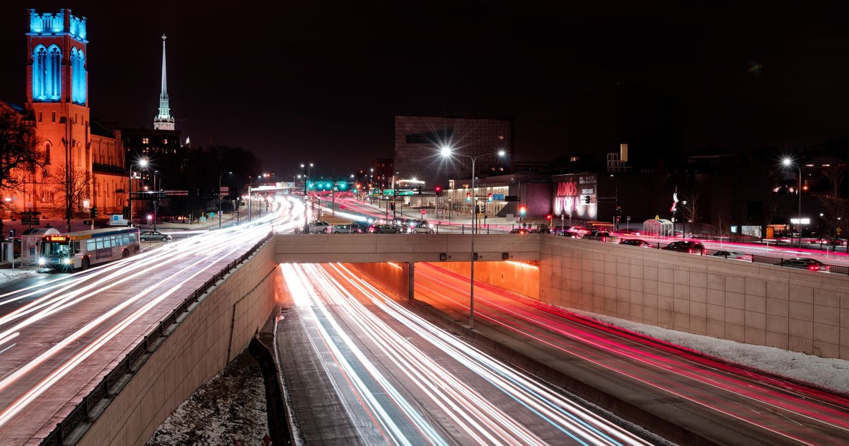 Dynamic long-exposure shot of illuminated city streets in Minneapolis at night.