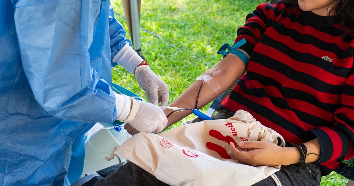 A woman donating blood during a community drive in Piura, Peru. Health awareness.
