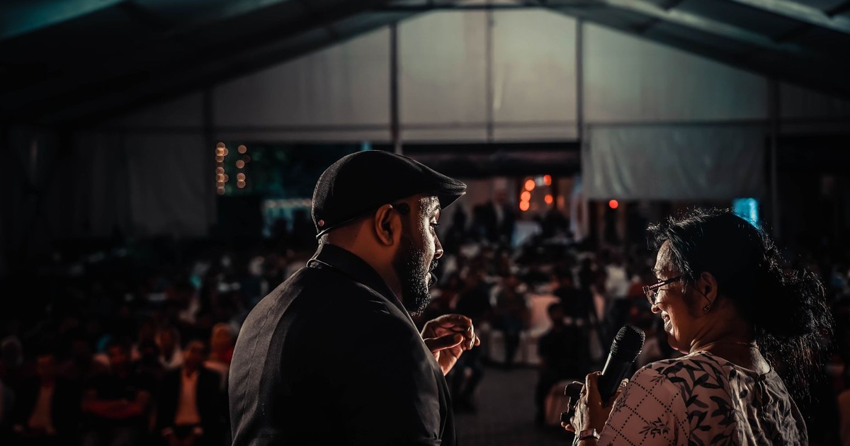 Performers captivating the audience at an evening indoor event, rich in ambiance and energy.
