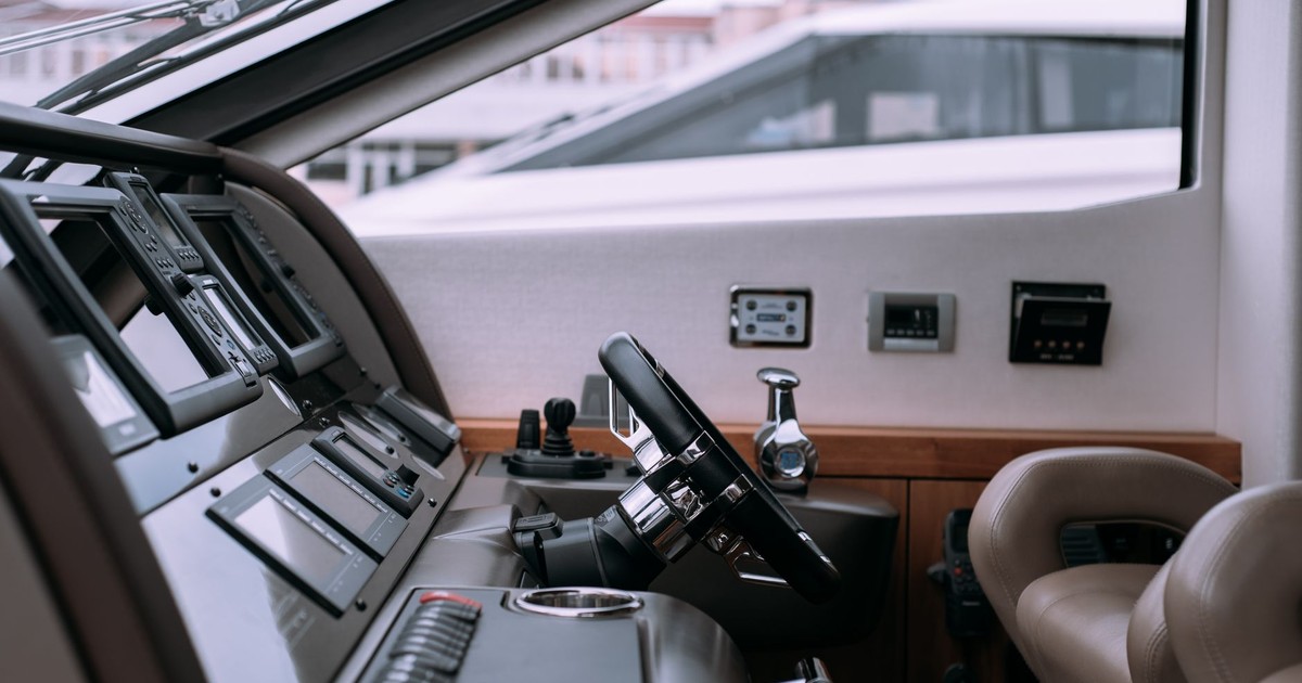 Interior of a luxury yacht showing steering wheel and advanced controls.