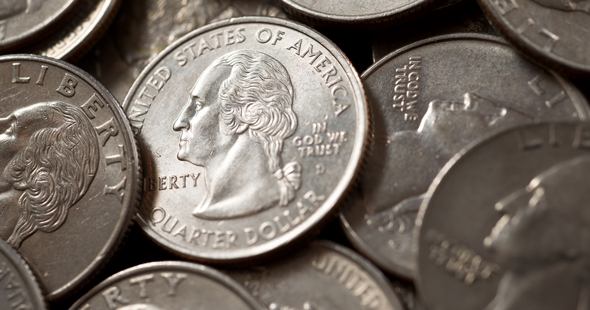 Quarter dollar coins on a black table