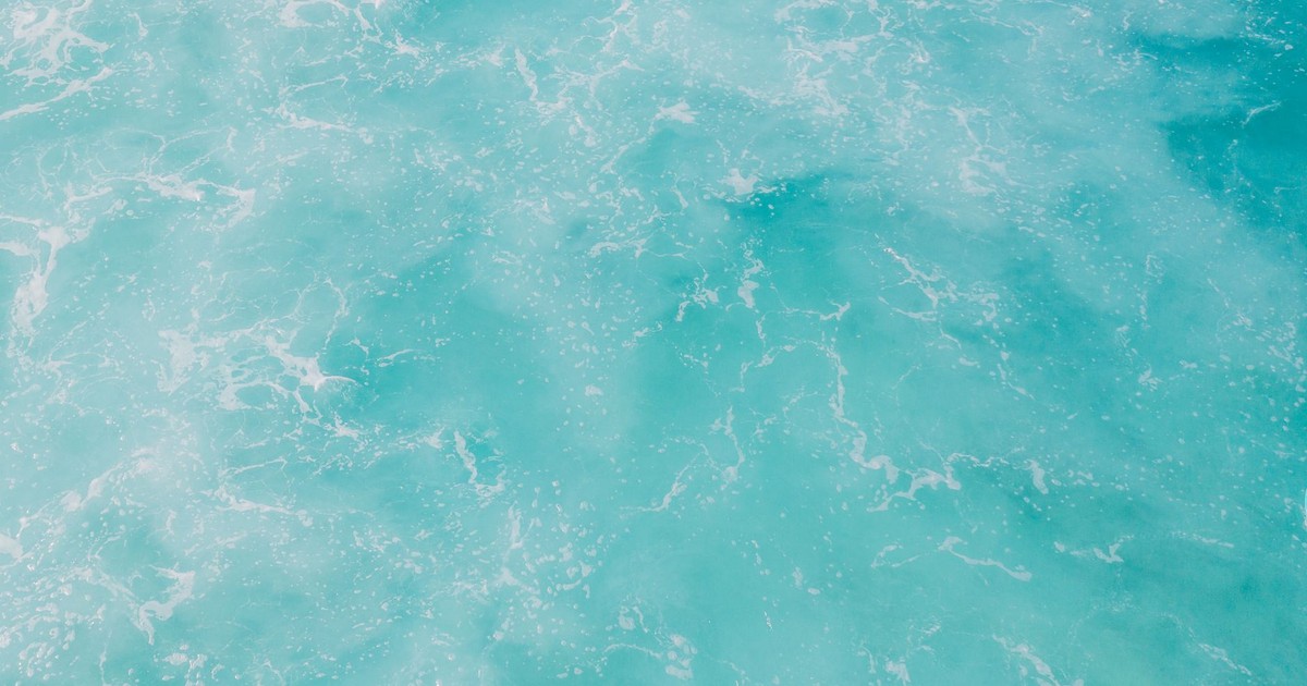 A soothing view of turquoise ocean waves forming natural, artistic patterns.