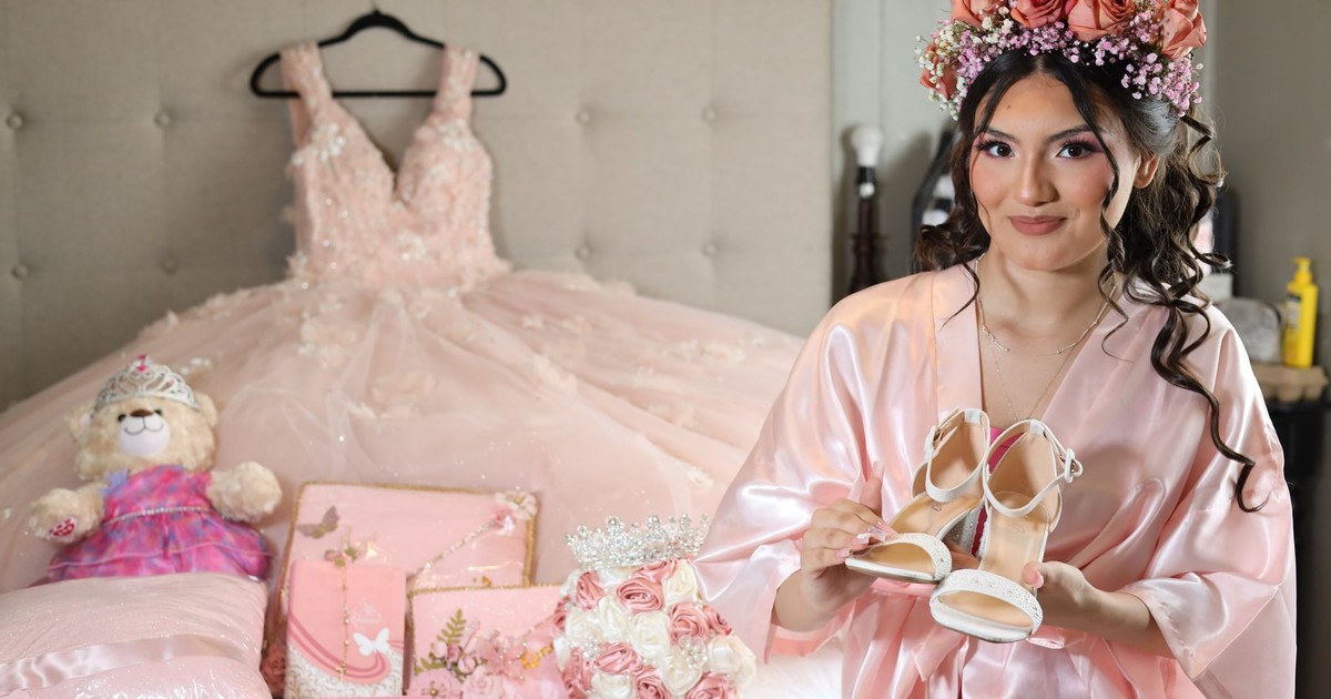 Young woman preparing for her quinceañera, surrounded by pink decorations.