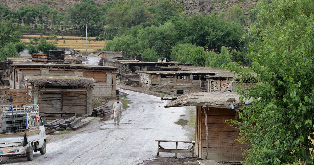 A serene rural village in Afghanistan, showcasing traditional architecture and lush greenery.