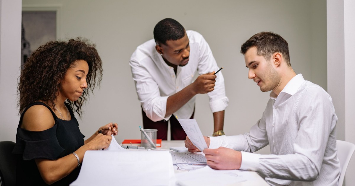 A diverse team in an office setting engaged in a collaborative brainstorming session.