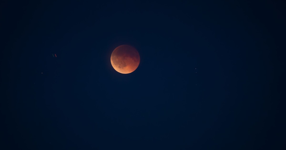 A breathtaking view of a lunar eclipse captured in the starry night sky above Würzburg, Germany.