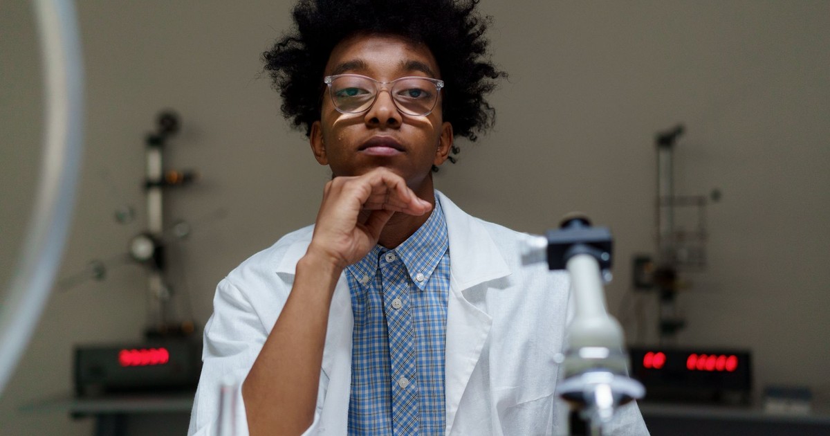 Portrait of a thoughtful scientist with eyeglasses in a laboratory setting.