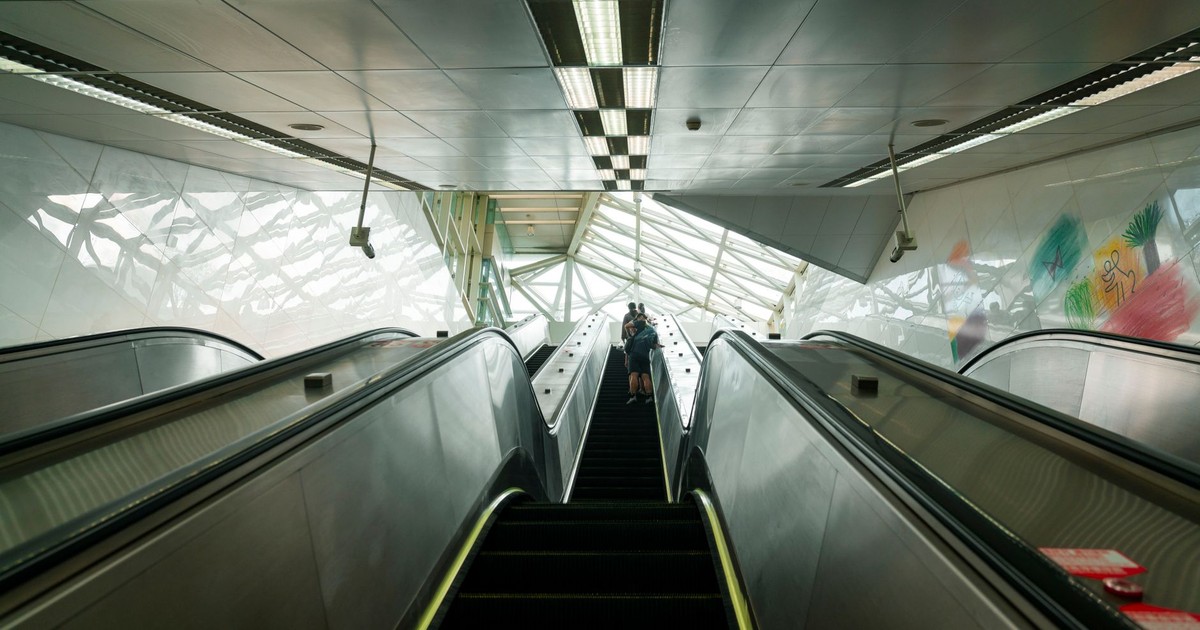 View of an escalator in a modern Taipei metro station with unique architecture.