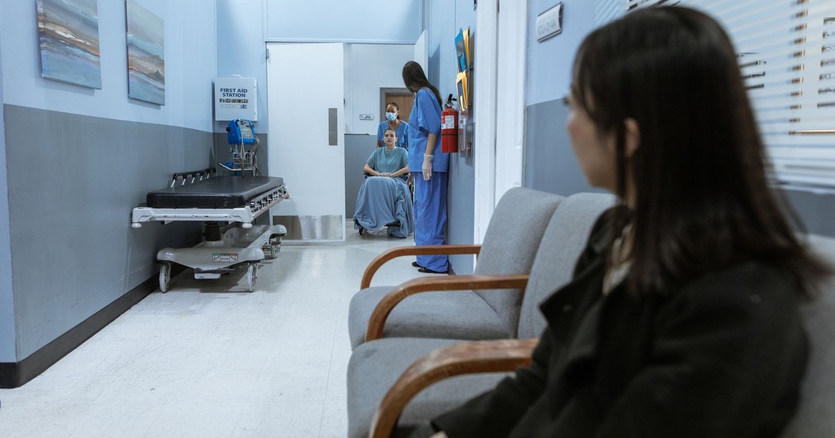 A hospital scene showing patients and medical staff in a corridor, illustrating healthcare environments.