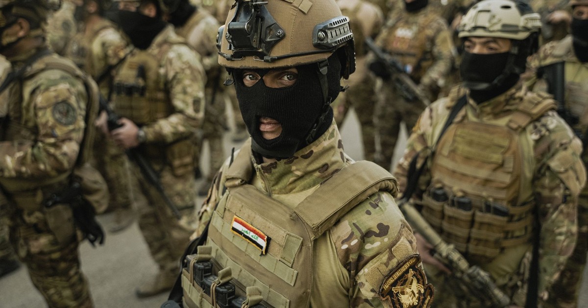 Group of soldiers in full combat gear, focused and prepared for action in a military operation setting.