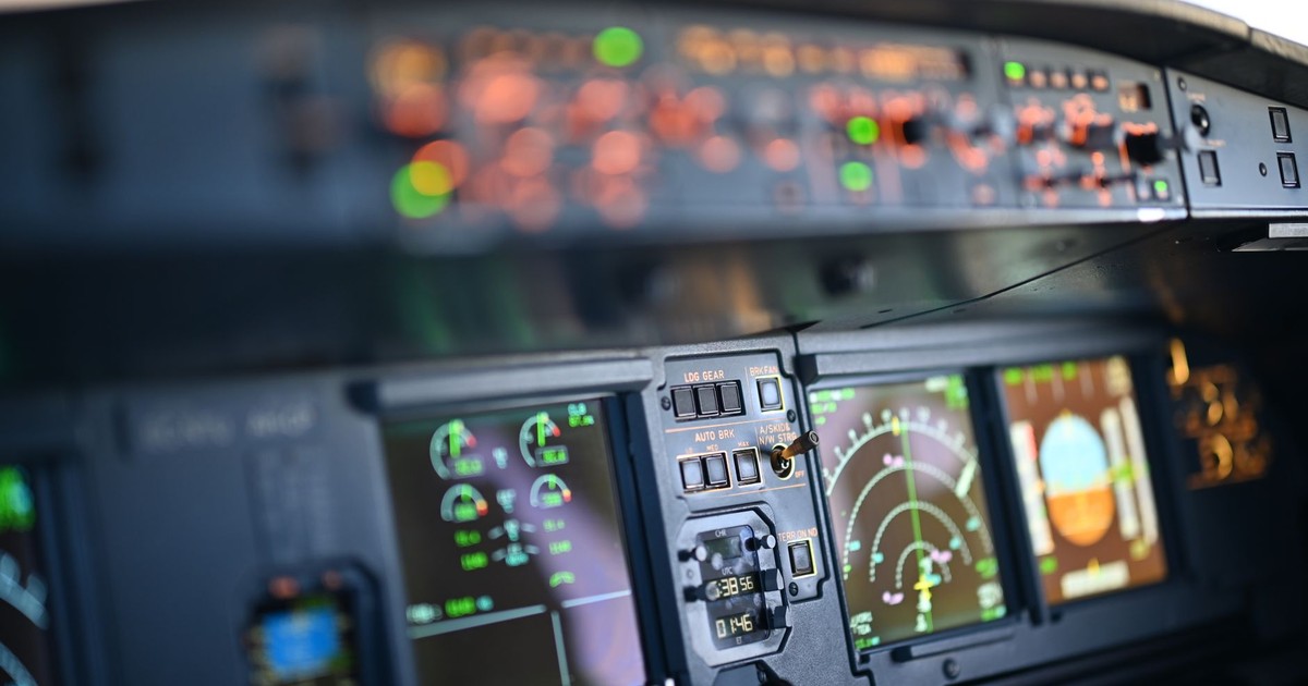 Close-up view of airplane cockpit instrumentation with modern digital displays.