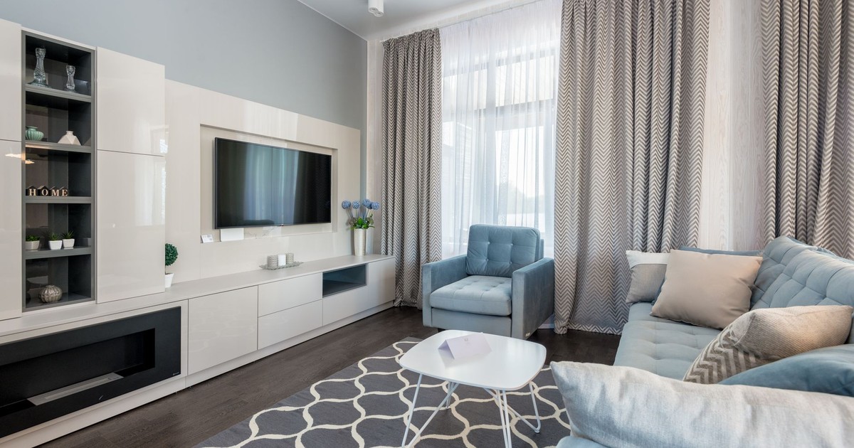 Bright and cozy modern living room featuring minimalist design and blue accents.
