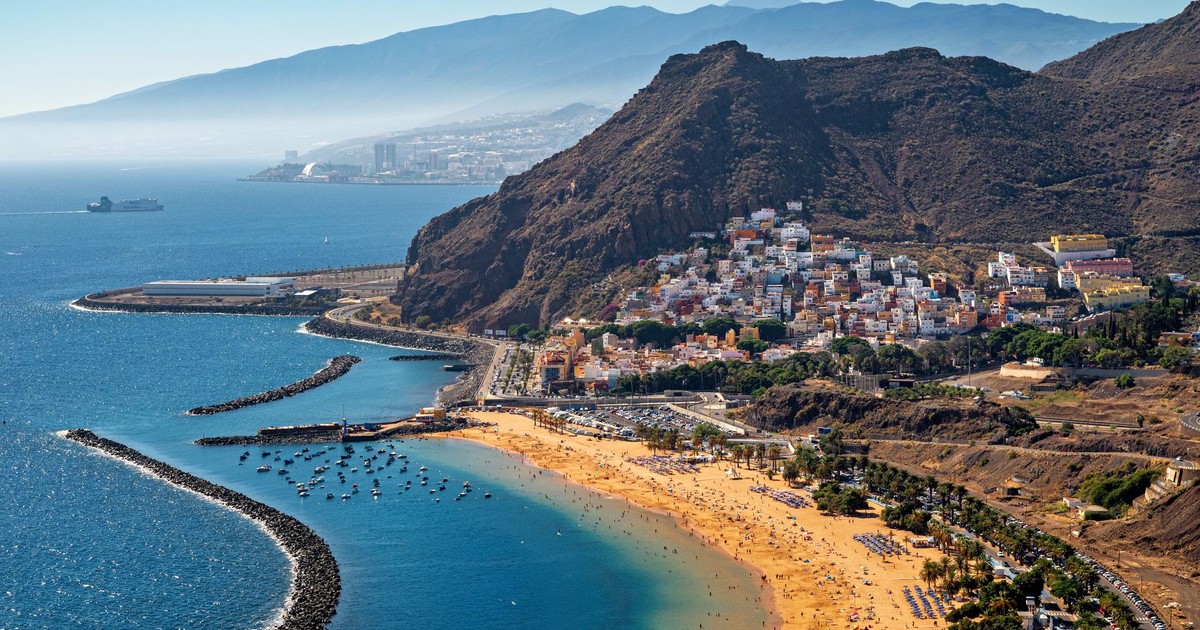 Stunning aerial view of Playa de Las Teresitas in Tenerife with mountainous backdrop.
