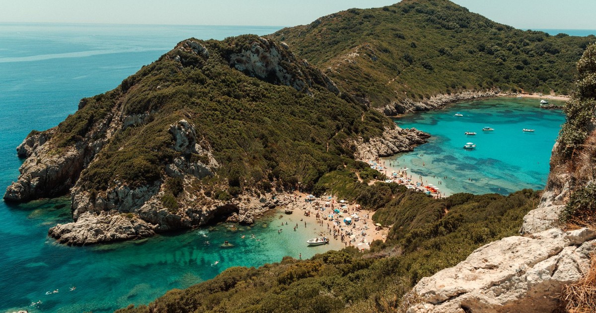 Breathtaking aerial shot of Porto Timoni Beach with turquoise waters and lush greenery in Corfu, Greece.